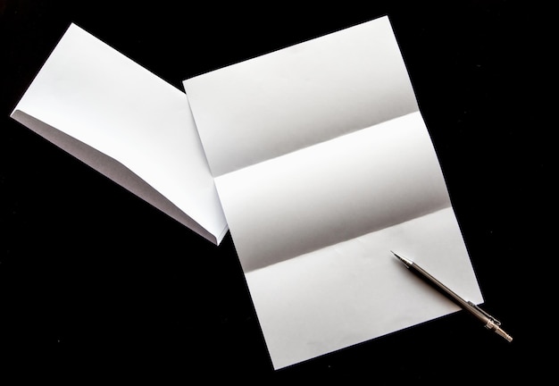 Photo blank of letter paper and white envelope with pen