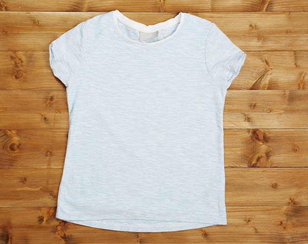 Blank light tshirt on wooden background