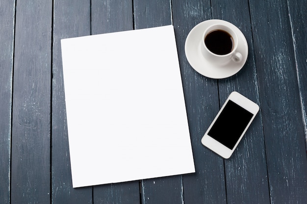 Blank magazine or catalogue cover mockup, with coffee cup and smartphone