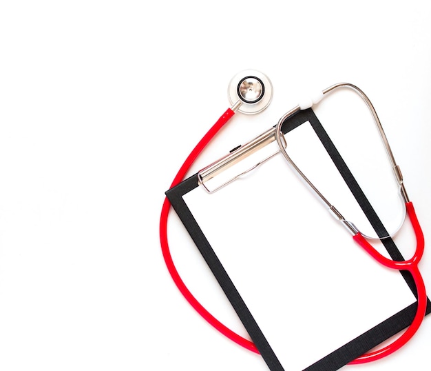 Blank medical clipboard with red stethoscope on white background Copy space