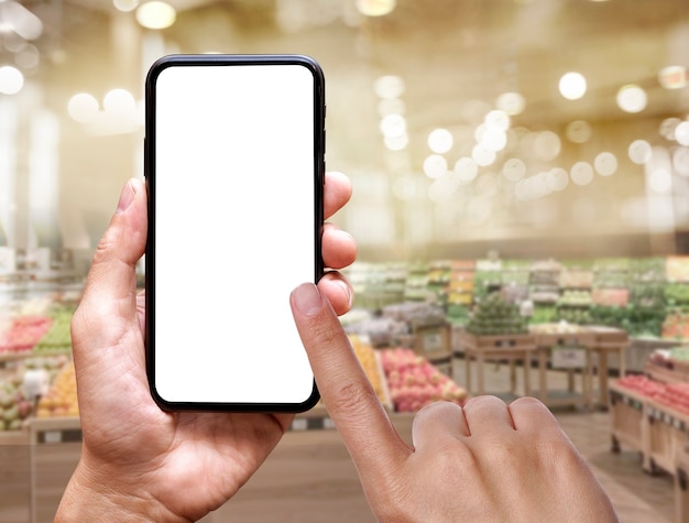 blank of mobile screen in hand at fresh market