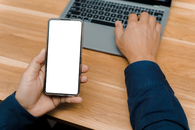 Blank mockup, white screen, mobile phone.men holding text messages using mobile relaxing on sofa at home. empty space background for ads marketing business