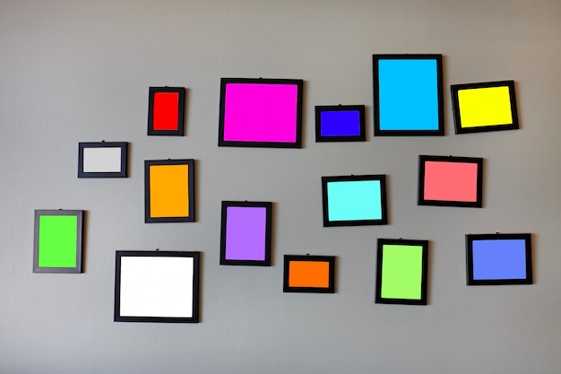 Blank multi color in photo frames on grey cement wall