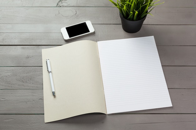 Blank note book on table, top view