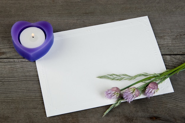 Blank note, garden flowers and aroma candle 