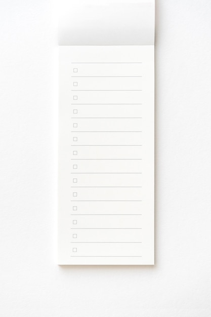 Blank note paper pad isolated on gray with clipping path. Close-up.