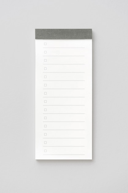 Blank note paper pad isolated on white with clipping path. Close-up.