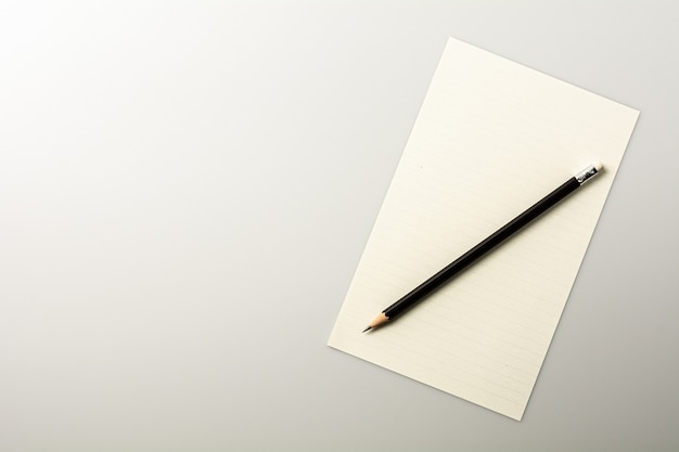 Blank note paper and a pencil on white desk.