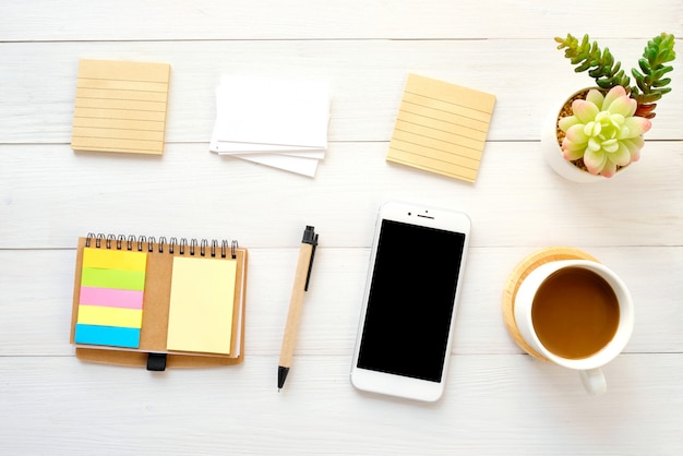 Blank note papers, business card, smart phone, pen and coffee on white 