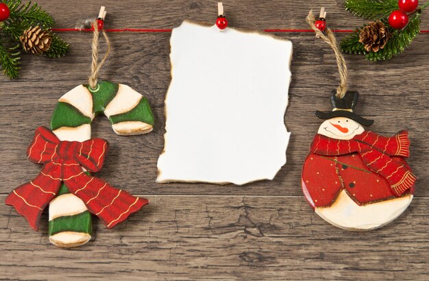 Blank note with christmas decoration on wooden background