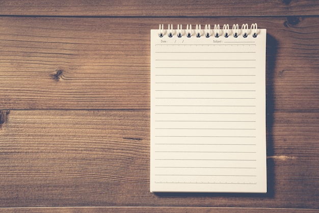 Photo blank notebook on brown wood table