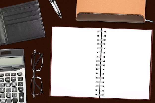 blank notebook or diary and pocket card with glasses