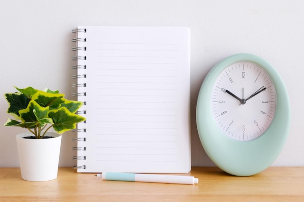 Blank notebook paper on wooden table background mock up template