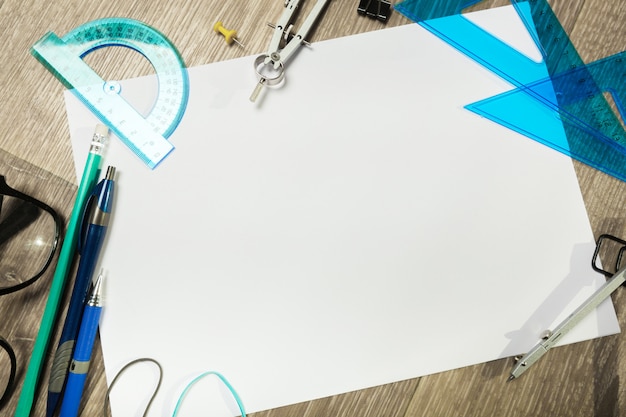 Blank notebook and pencil with glasses on wooden table