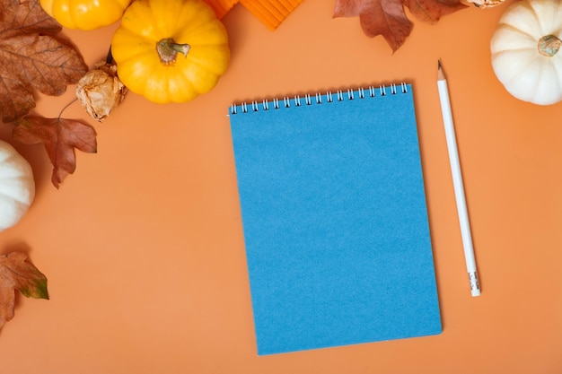 Blank notebook for text next to pumpkins and autumn leaves Autumn theme mockup