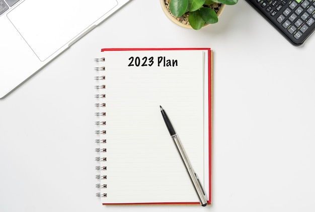 Blank Notebook with 2023 for action plan on working desk office Business planing and action plan to achieve target and goal concept