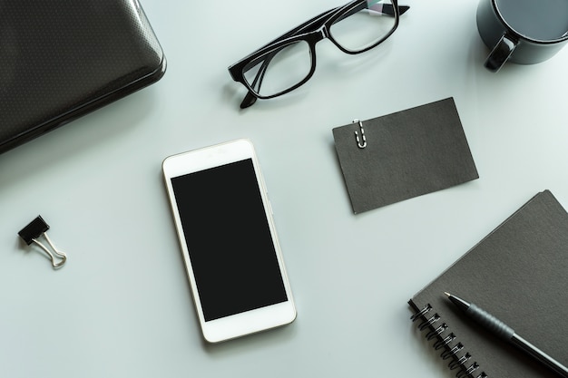 Blank notebook with cellphone desk office