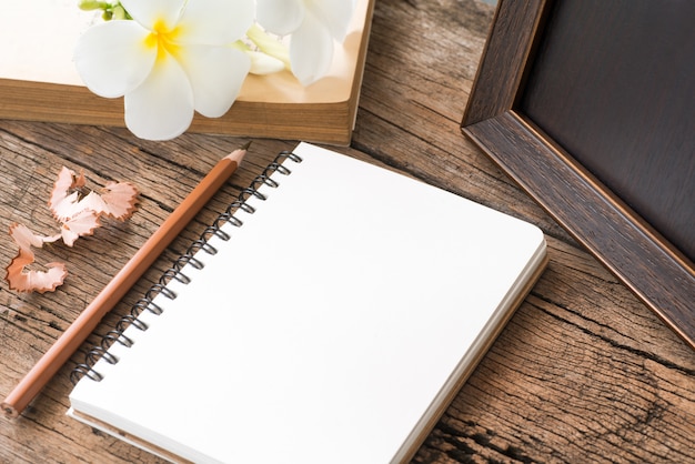 Blank notebook with pencil on wooden table, business 