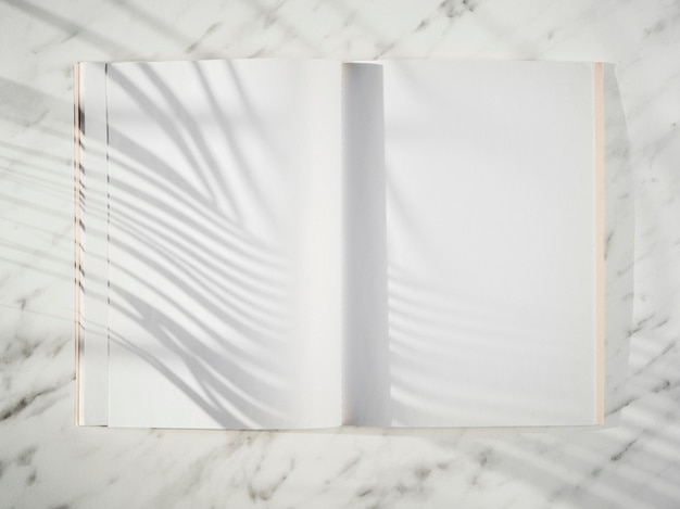 Photo blank notebook with shadows top view