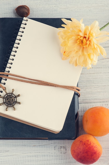 Blank notebooks, apricots, flower