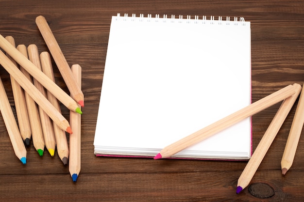 Blank notepad and colorful pencils