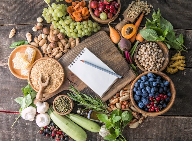 Blank notepad for copy space and  food ingredients on wooden table