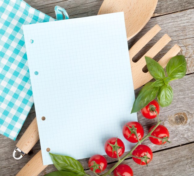 Blank notepad paper for your recipes with tomatoes and basil