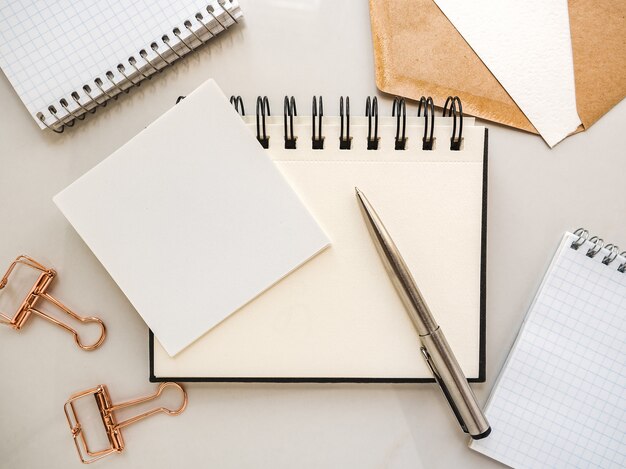 Blank notepad sheet and calendar for your congratulatory message. Closeup, top view. No people. Concept of preparation for a holiday. Congratulations for relatives, friends and colleagues