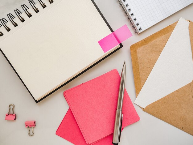 Blank notepad sheet and calendar for your congratulatory message. Closeup, top view. No people. Concept of preparation for a holiday. Congratulations for relatives, friends and colleagues