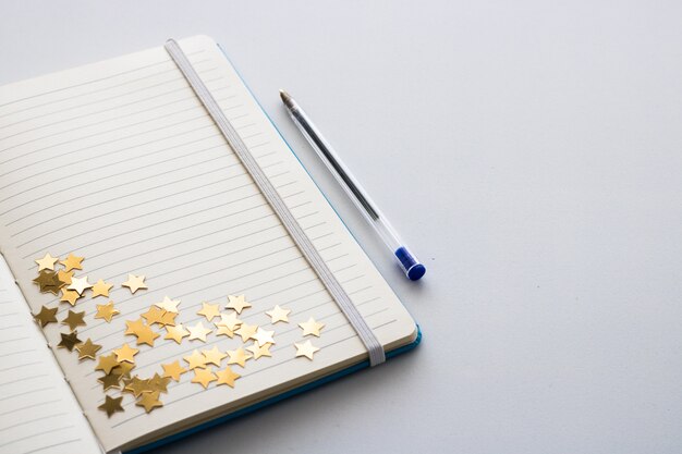 Blank notepad with glitter stars. Space for text.