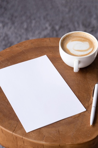 Photo blank notepaper mockup on coffee table with cappuccino pen and grey rug