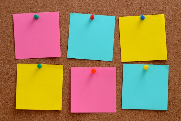 Blank notes pinned into brown corkboard