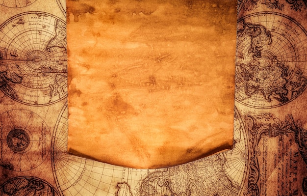 Photo blank old paper with curled edge against the background of an ancient map