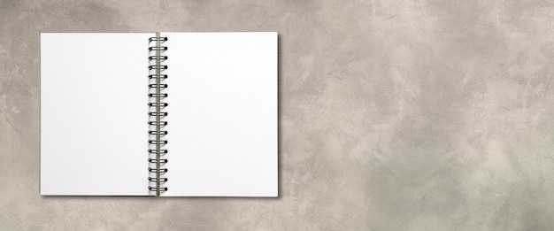 Blank open spiral notebook mockup isolated on concrete banner