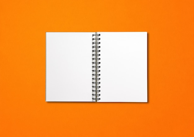 Blank open spiral notebook mockup isolated on orange background