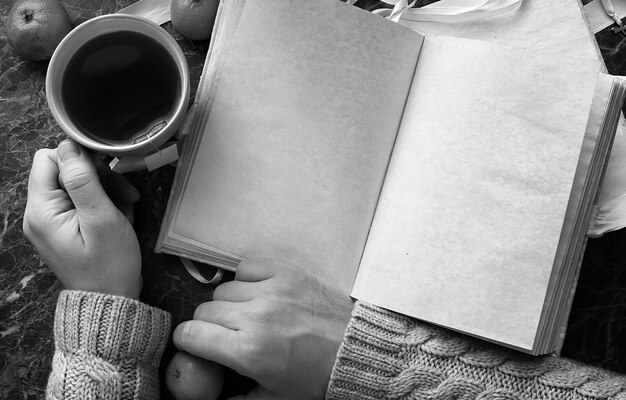 blank pages opened vintage book on green marble countertop