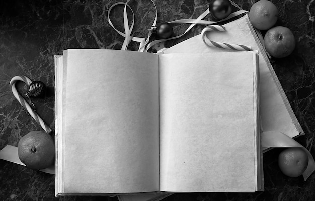 Photo blank pages opened vintage book on green marble countertop