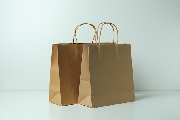 Blank paper bags on white