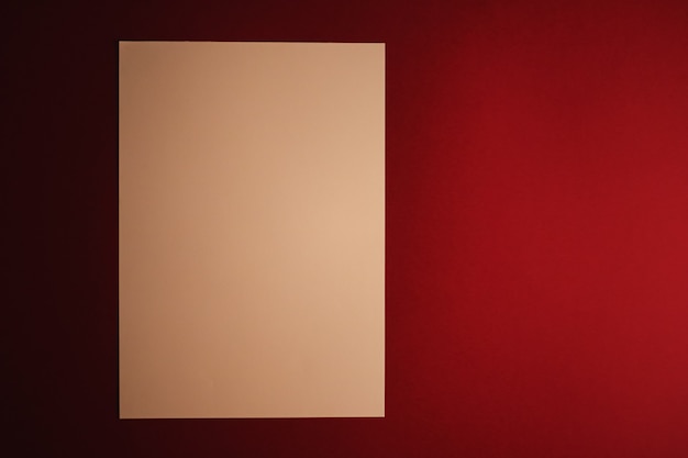 Blank a paper beige on dark red background as office stationery flatlay luxury branding flat lay and...