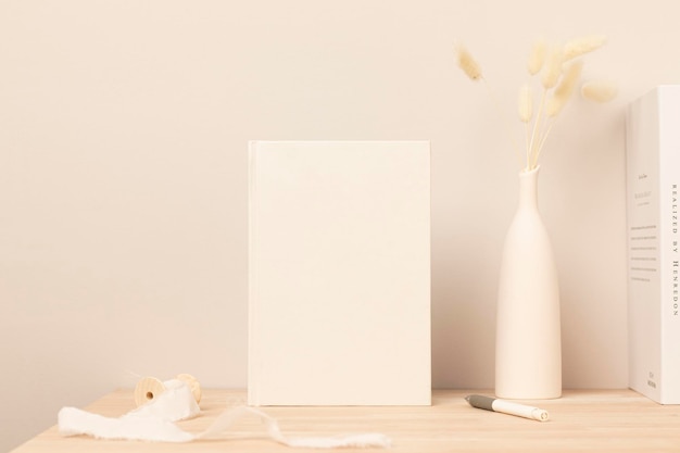 Blank paper card, greeting card mock up. decoration with dried Bunny Tail and pampas grass, Front view, Beautiful Bunny Tail grass in vase on wood table and beige cement wall background