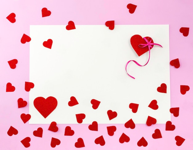 Blank paper card with copy space Red hearts on a pink background valentine day greeting cardFlat laycopy space