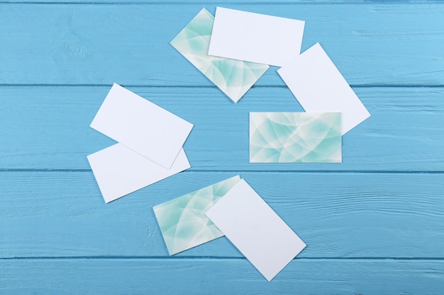 Blank paper cards for branding on blue wooden background