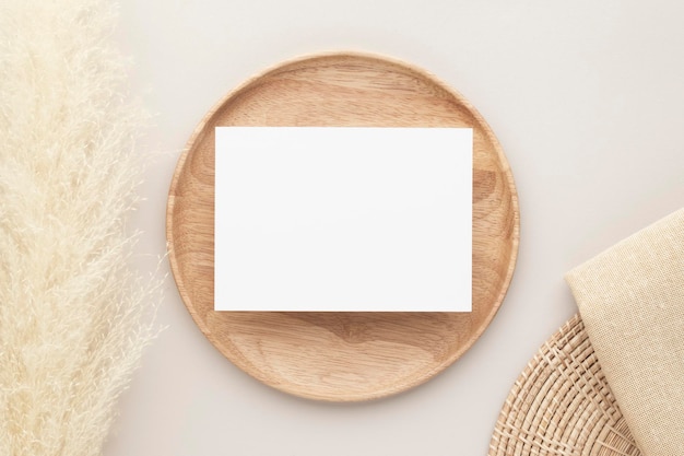 Blank paper cards, Mockup with pampas grass on a wooden plate, beige background, Minimal beige workplace composition, flat lay, mockup