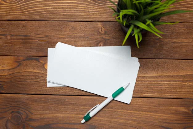 Blank paper, envelope on wooden table