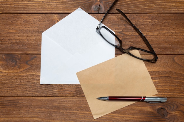 Blank paper, envelope on wooden table