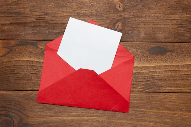 Blank paper, envelope on wooden table