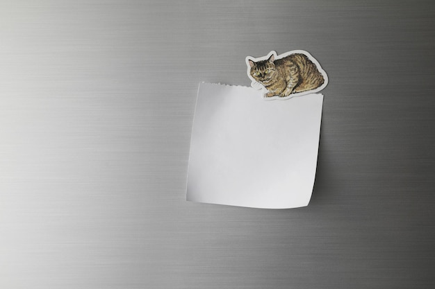 Blank paper on fridge door with cat magnet