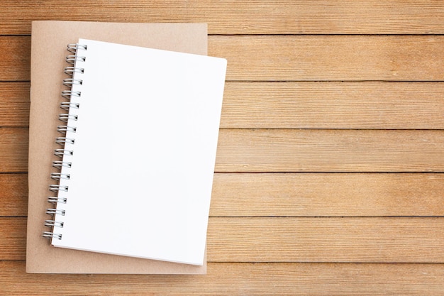 Photo blank paper notebook on brown wooden table