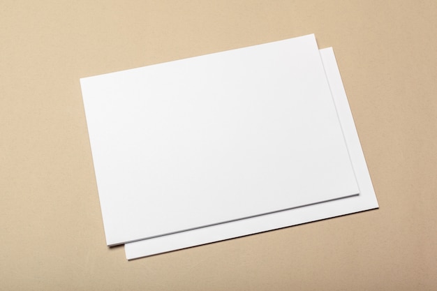 Photo blank paper pieces on a beige surface