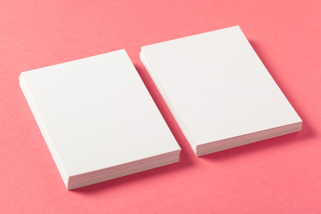 Blank paper pieces  on a colored pink background